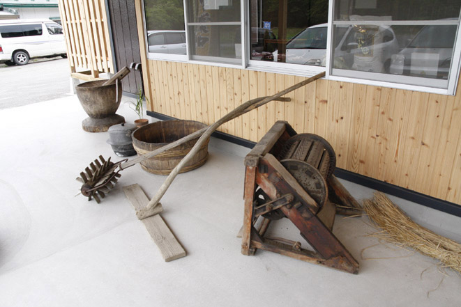 店の外には昔の農作業を思わせる農機具が置かれている